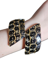 Load image into Gallery viewer, 1950s Black and Gold Confetti Lucite Clamper Bangle
